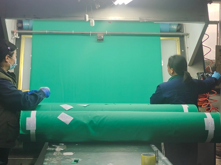 Finished flame-resistant fabric undergoing final roll inspection before packing