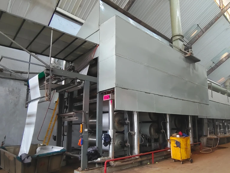 Flame-resistant fabric undergoing flame-retardant treatment on a continuous finishing line